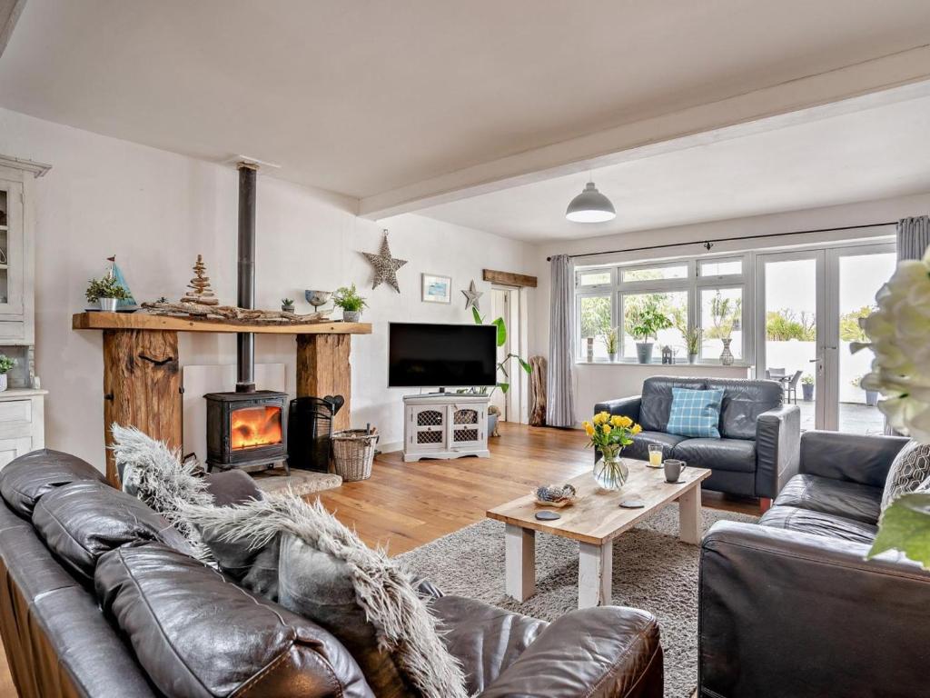 a living room with a couch and a fireplace at 2 Bed in Swansea oc-78845 in Ilston