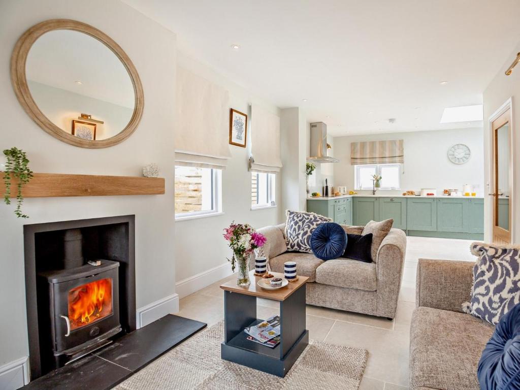 a living room with a fireplace and a couch at 3 Bed in Pwllheli oc-95040 in Morfa Nefyn
