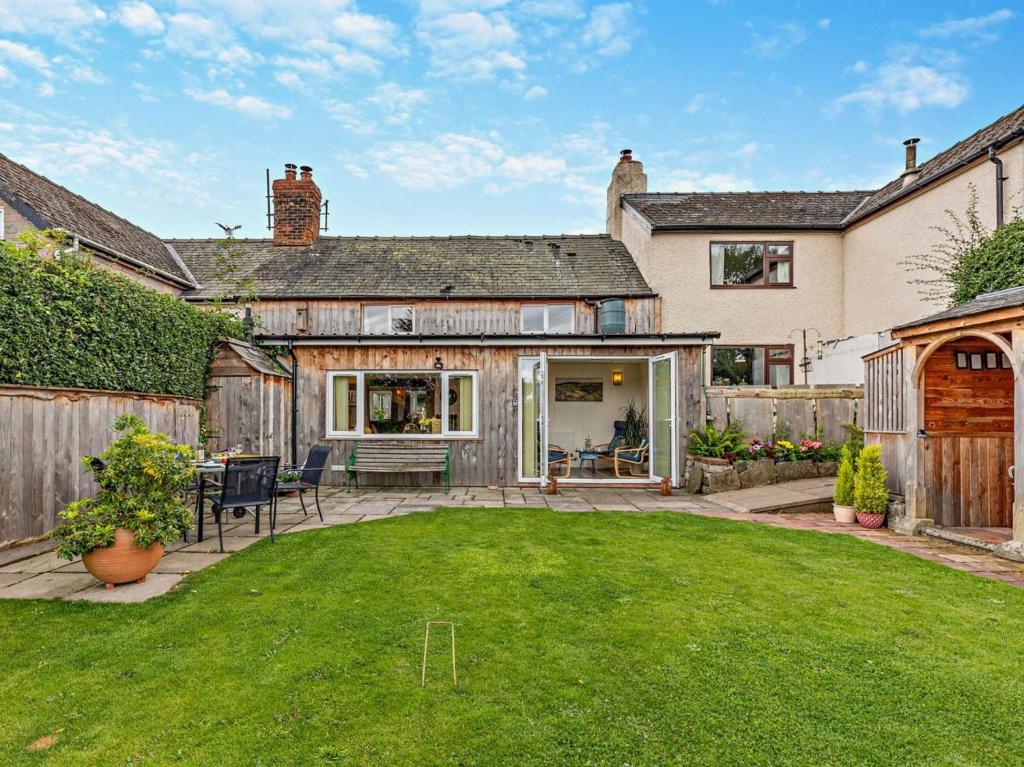 a backyard of a house with a lawn and a fence at 2 Bed in Craven Arms oc-83166 in Clun
