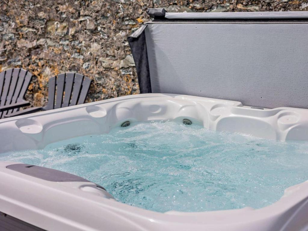 a jacuzzi tub with blue water in it at 4 Bed in Amlwch oc-90258 in Llanfechell