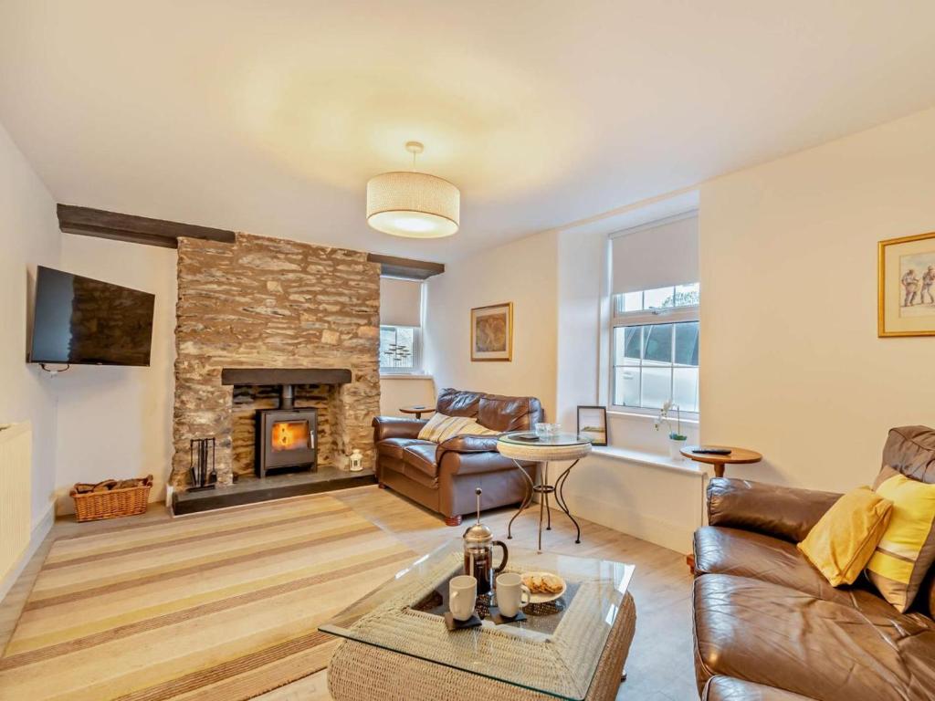 a living room with a couch and a fireplace at 4 Bed in Cardigan oc-94137 in Aberporth