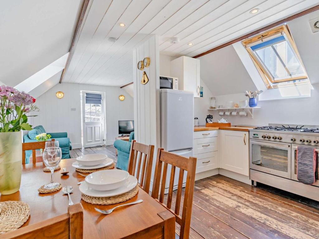 a kitchen and dining room with a table and chairs at 1 Bed in New Quay oc-45927 in New Quay