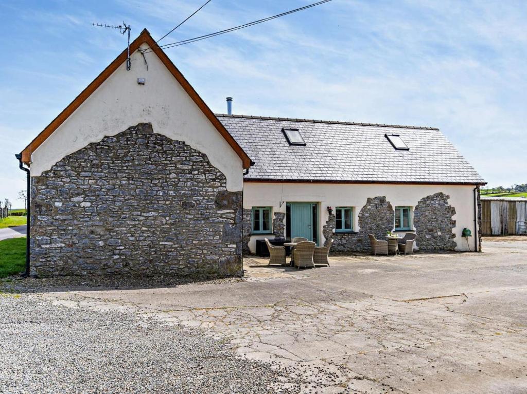 an old stone building with a group of chairs outside at 1 Bed in Narberth oc-72867 in Whitland