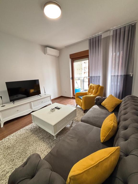 a living room with a couch and a flat screen tv at Ana Lux Master Apartment 14 in Podgorica