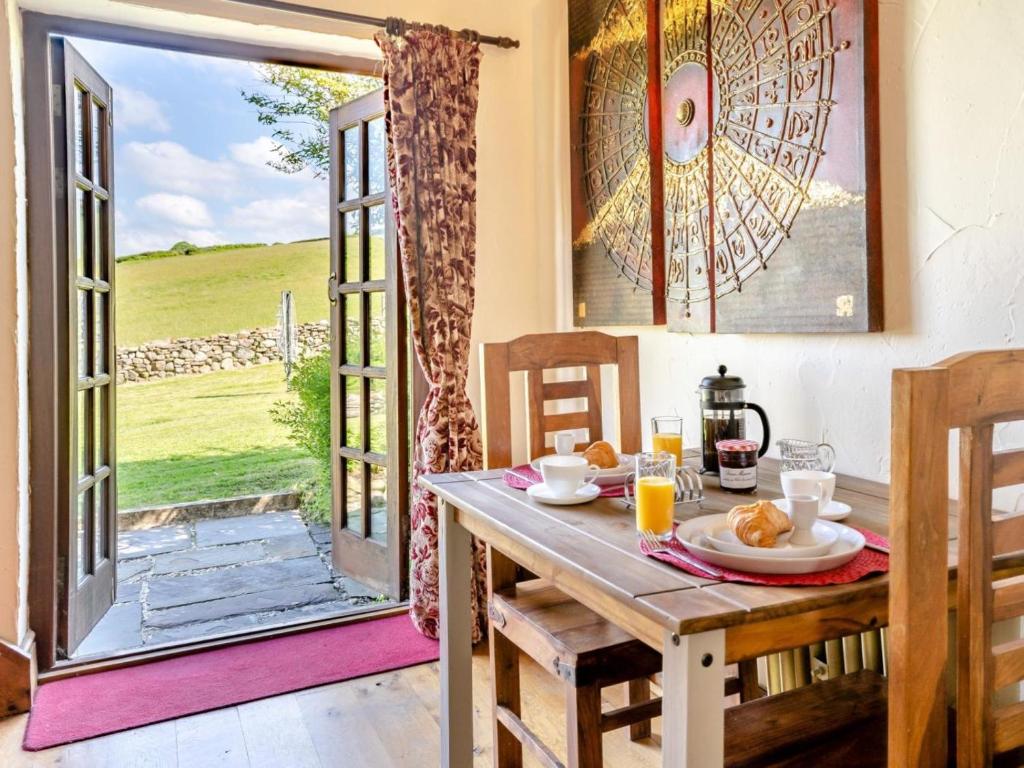 a dining room with a table and an open door at 1 Bed in Swansea oc-77981 in Penclawdd
