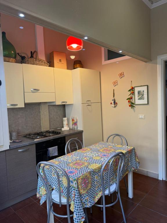 a kitchen with a table with chairs and a stove at Luxury Apartment Golden Dreams in Reggio di Calabria