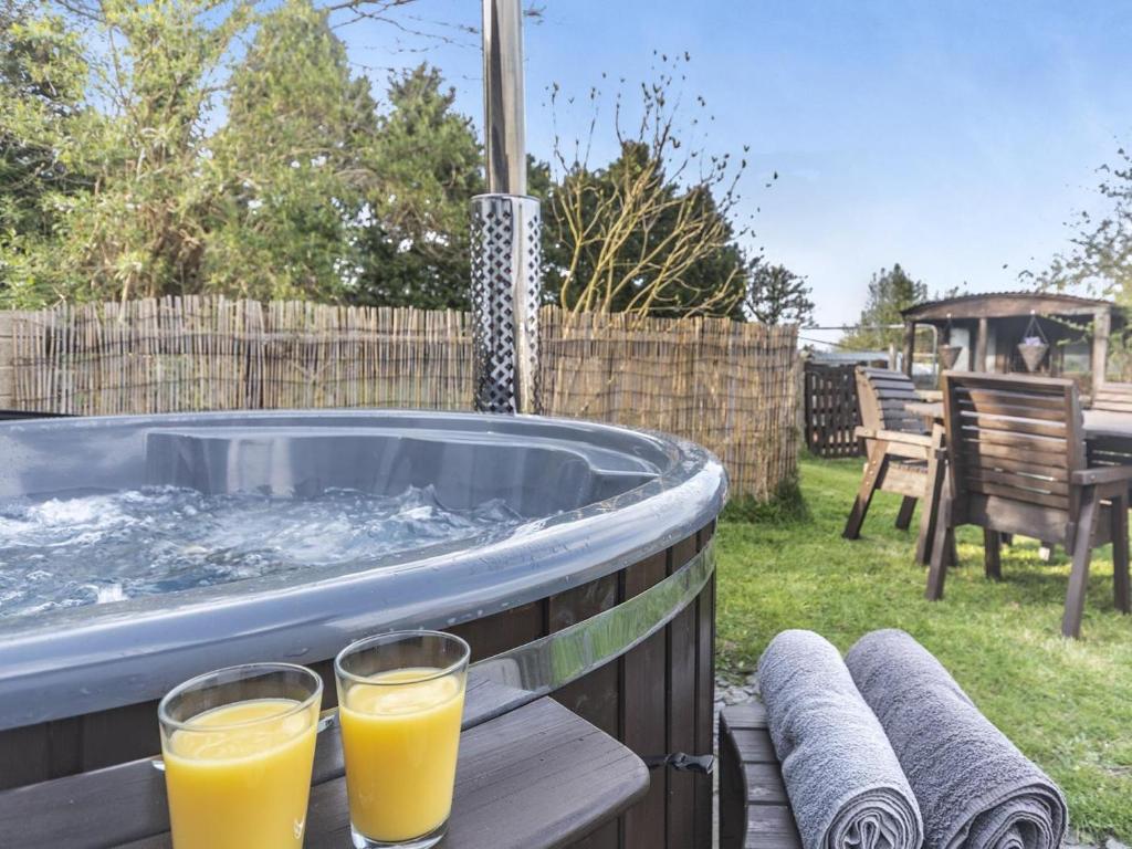 two glasses of orange juice sitting on a hot tub at 2 Bed in Mold oc-90461 in Caerwys