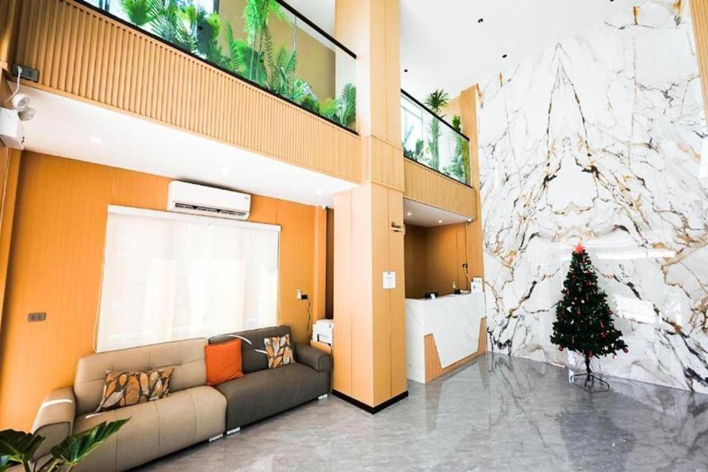 a living room with a couch and a christmas tree at VELIN Pattaya Hotel-Central Pattaya-3 in Pattaya