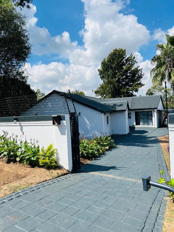 a house with a driveway and a white garage at 15 On Candy in Midrand