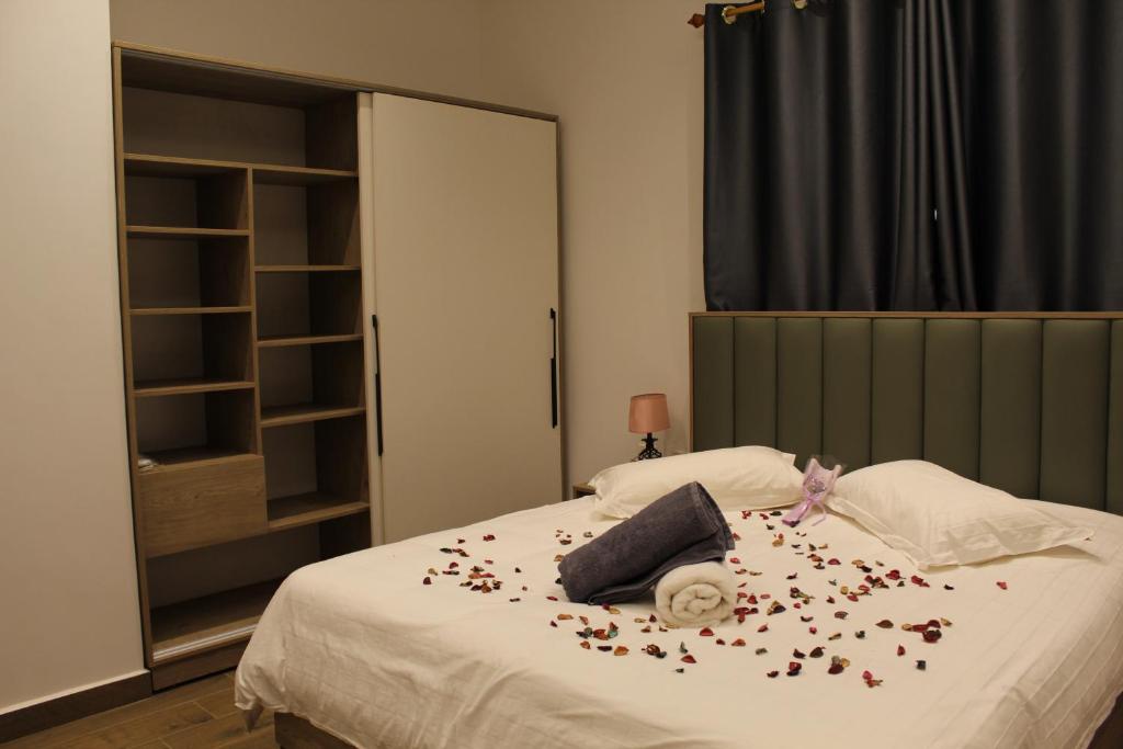 a bedroom with a bed with confetti on it at two seasons hotel in Bangui