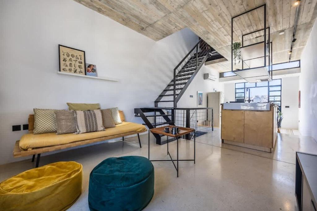 a living room with a couch and a table at Birkirkara Typical 2BDR Townhouse in Birkirkara