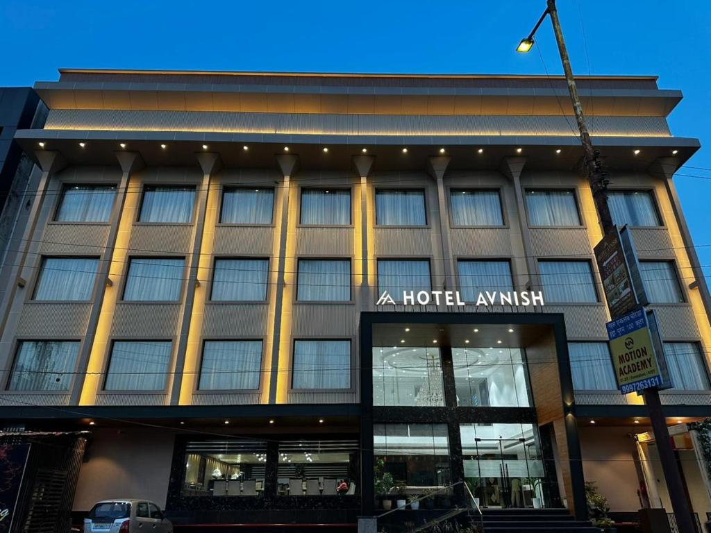 a large building with a hotel anytime sign on it at Hotel Avnish Near To Tajmahal in Agra