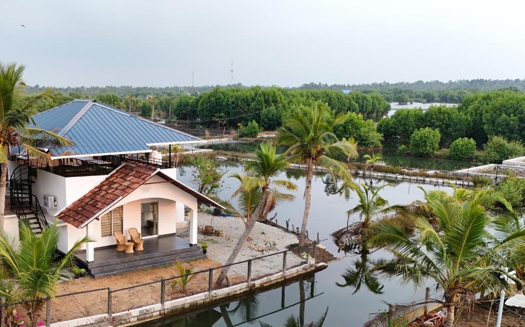 a house in the middle of a body of water at The Varghese Beth in Munroe Island