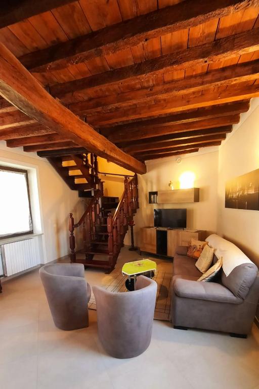 a living room with a couch and a staircase at CORTE MORONA in Marmirolo