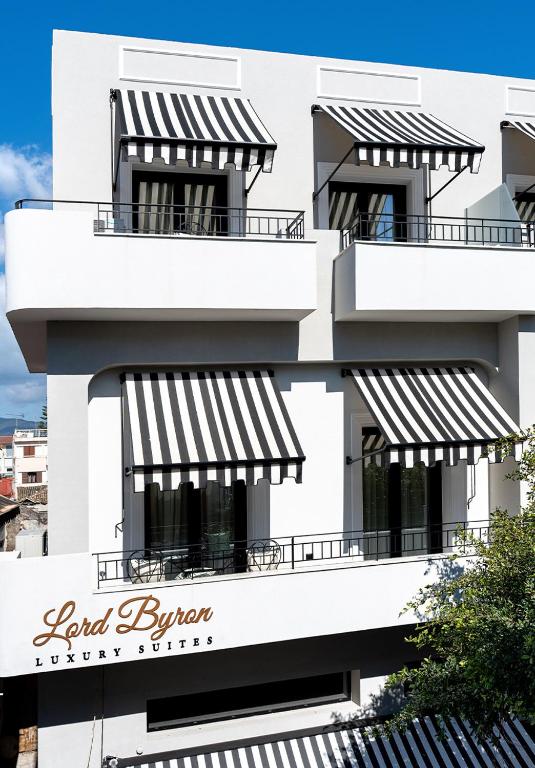 a building with black and white awnings on it at Lord Byron Luxury Suites in Missolonghi