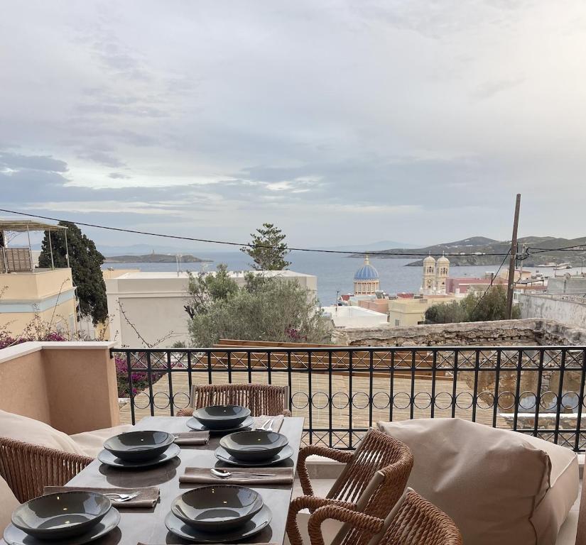 a table and chairs with a view of the ocean at VF34 Seaview House in Ermoupoli