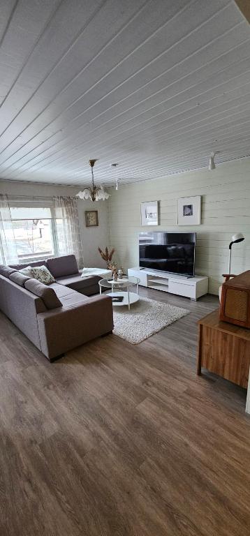 a large living room with a couch and a tv at Arctic House Kemi 7 GUEST, outdoor tentsauna Experience in Kemi