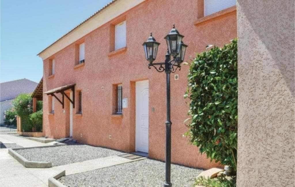a street light in front of a brick building at Maison à proximité de la plage in Prunete