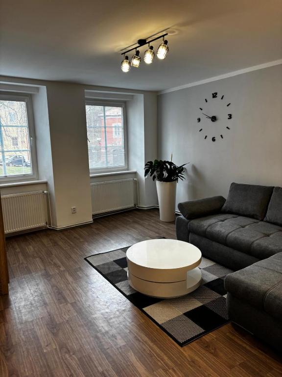 a living room with a couch and a coffee table at Apartmán u Hradu 2 in Cheb