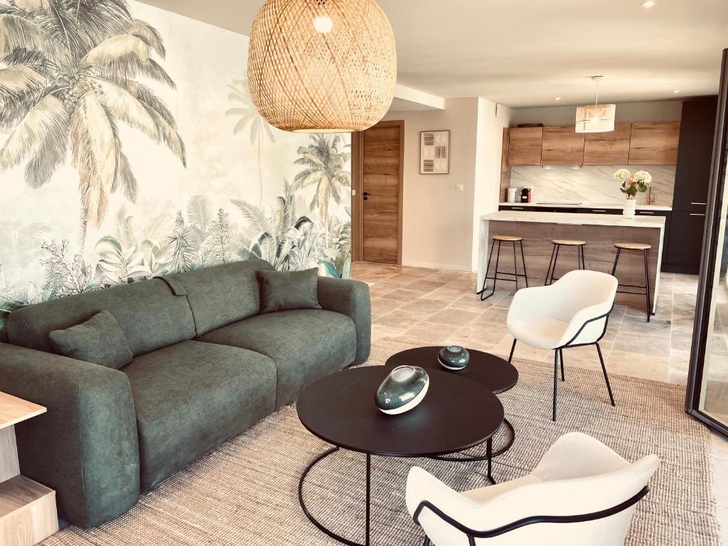 a living room with a couch and a table and chairs at La Maison Cavet 6 Appartements de standing au cœur du village in Sanary-sur-Mer