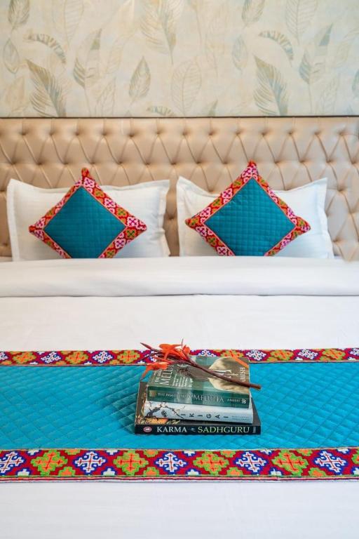 a bed with two beds with a book on it at Havana stays in Shoja