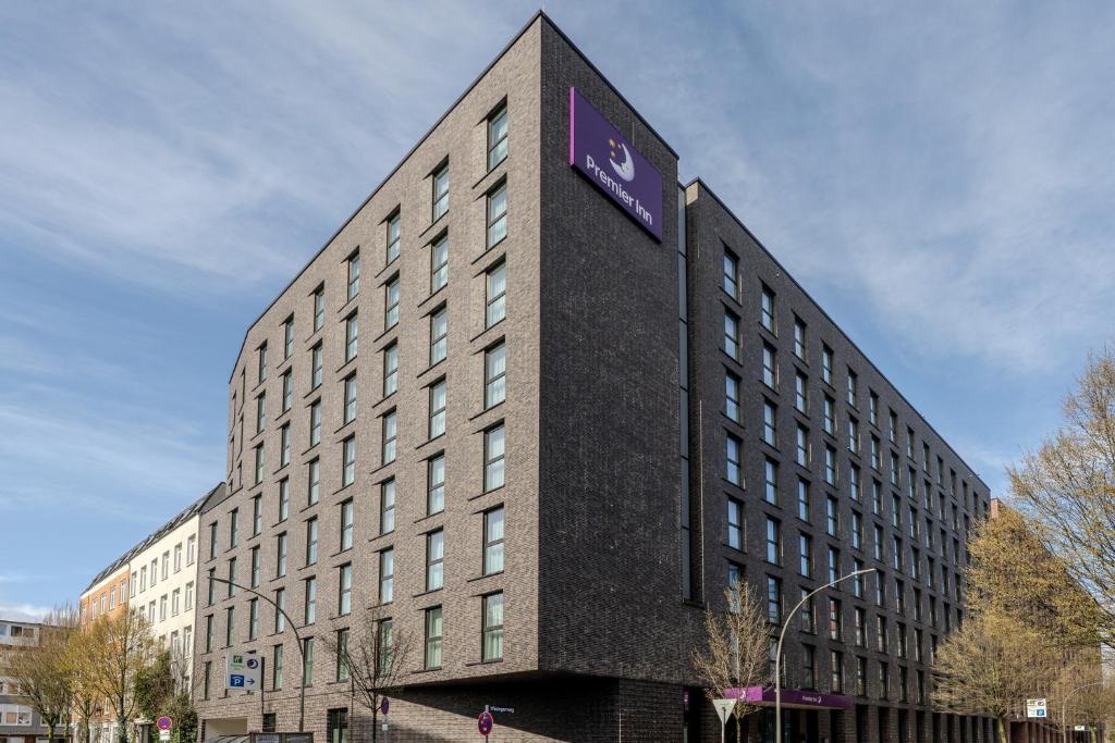 a tall building with a purple sign on it at Premier Inn Hamburg City Berliner Tor in Hamburg