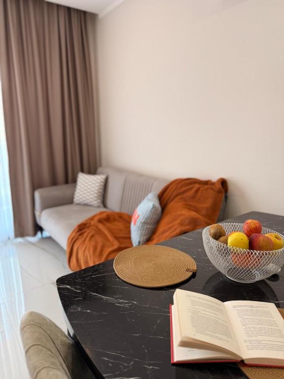 a living room with a table with bowls of fruit on it at Modern, Pool with slide,150m to beach in Alanya