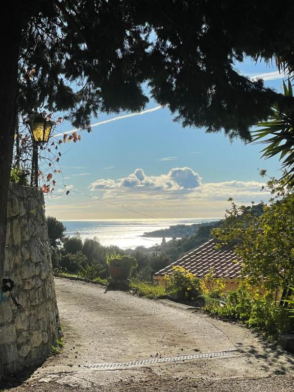 a gravel road with a view of the ocean at Studio Shangri-LA - Entrée & terrasse privatives - Vue mer - Parking in Menton