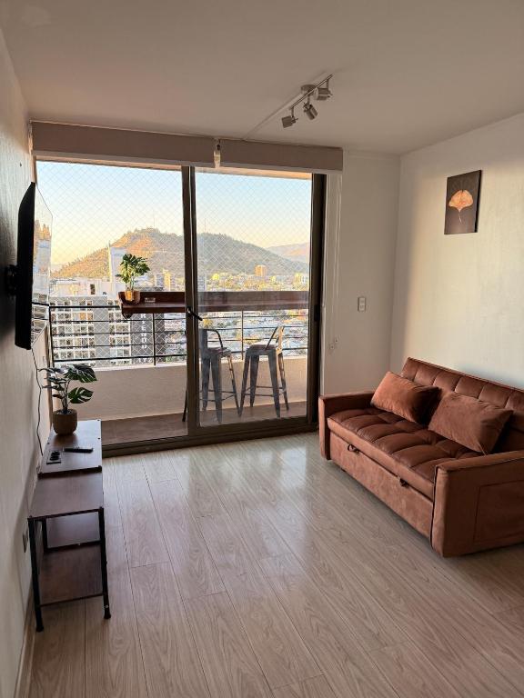 a living room with a couch and a large window at Ivan Suite More than accommodation an experience in Santiago