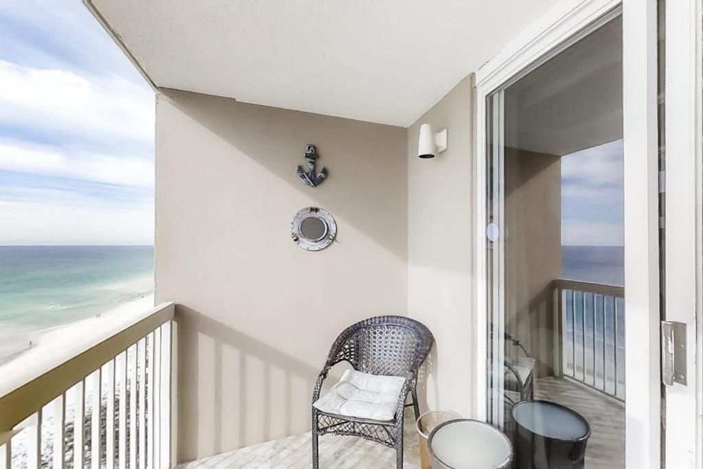 a balcony with a chair and a view of the ocean at Pelican Beach Resort 1502 in Destin
