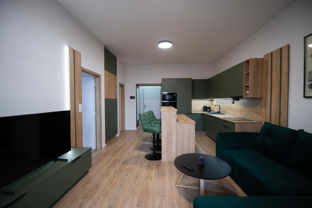 a living room with a couch and a kitchen at One Eleven 111 in Liptovský Mikuláš