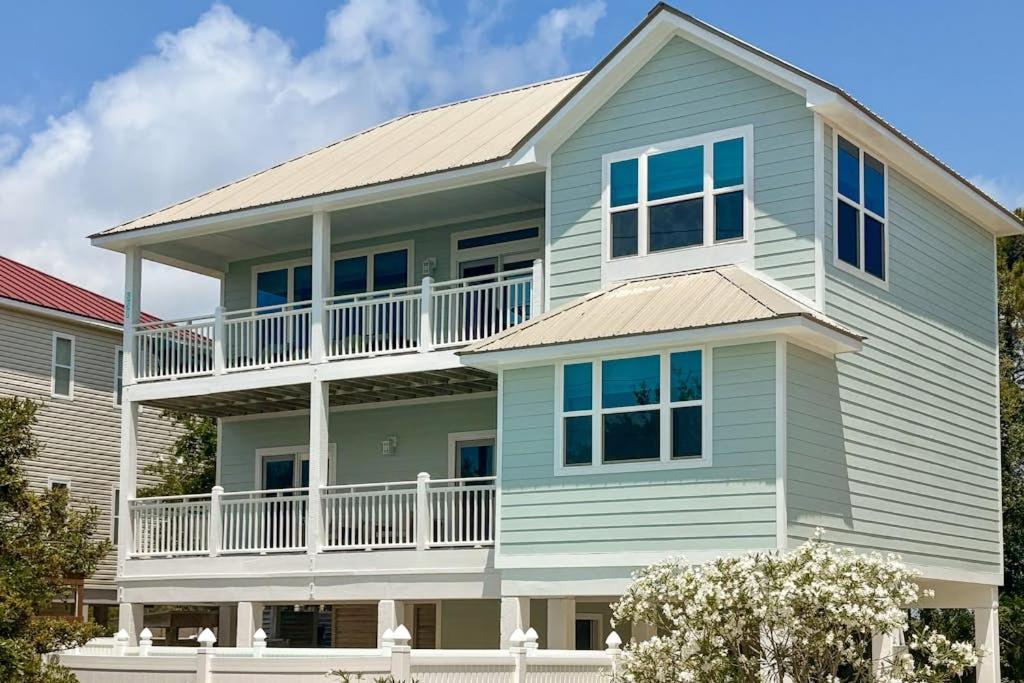 a large blue house with a large balcony at Serenity Now in St. George Island