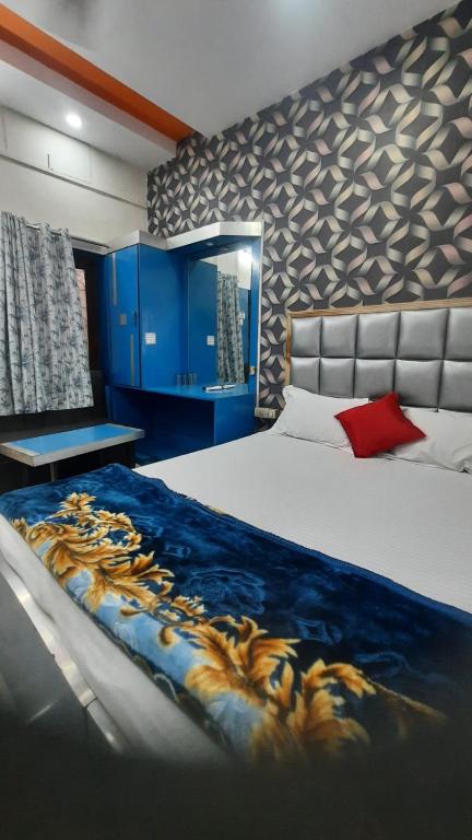 a bedroom with a large bed with a blue blanket at Hotel Savera in Rānchī