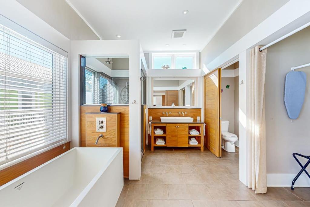 a bathroom with a tub and a sink at Sunshine Haven in Carrabelle