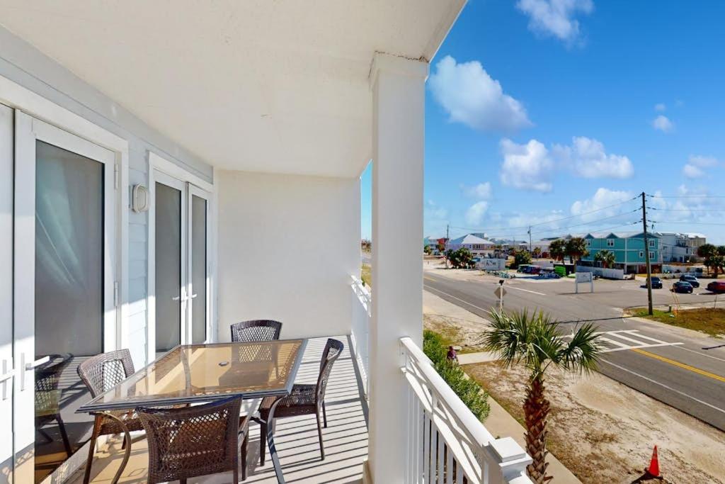 a balcony with a table and chairs and a street at Tranquil Harbour #211 in Mexico Beach