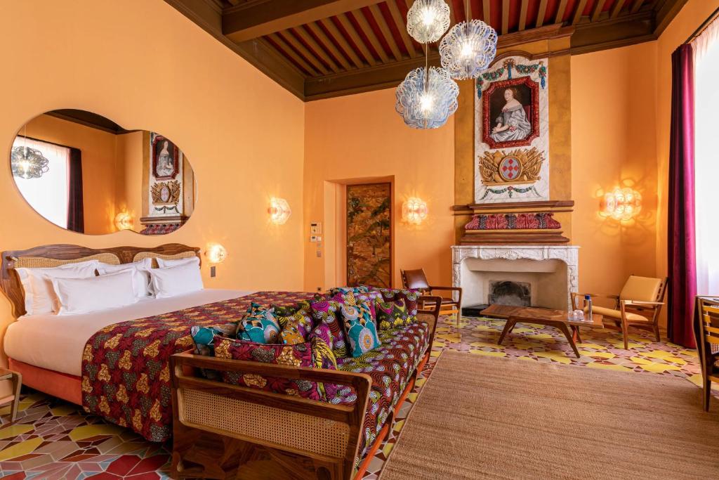 a bedroom with a bed and a fireplace at L'Arlatan in Arles