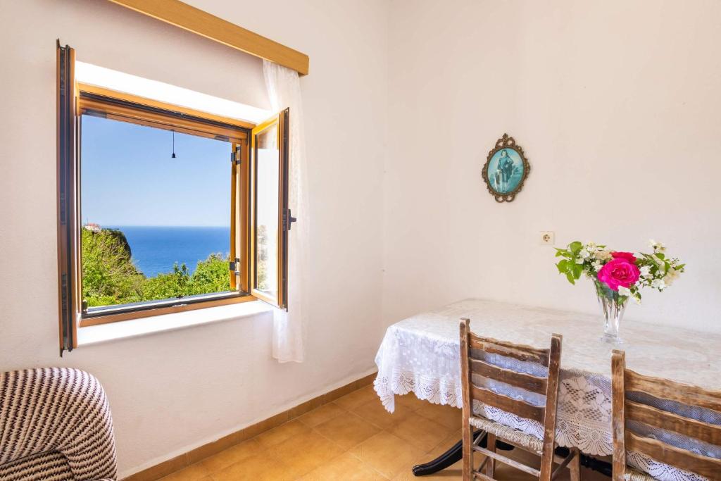 a dining room with a table and a window at Minas House in Mesochórion