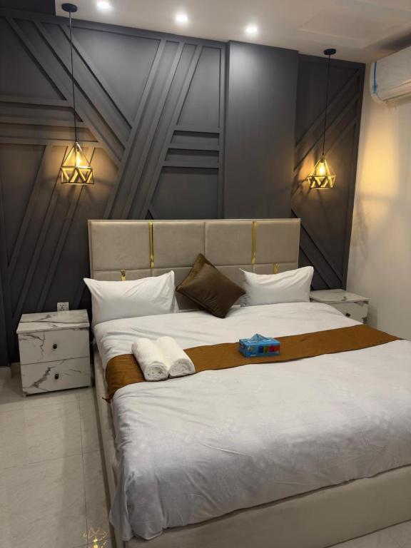 a bedroom with a large bed with two towels on it at Royale Rest Suites in Rāmkot
