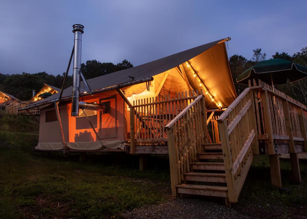 a luxury yurt with a staircase and lights on it at Huttopia Berkshires in Hancock