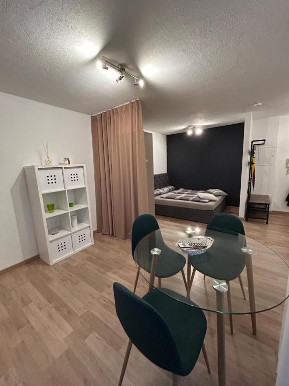 a living room with a glass table and chairs at Ferienwohnung Kestel in Bad Bellingen