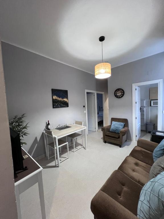 a living room with a couch and a table at Almendra B Vitalba Apartments in Lanjarón