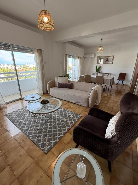 a living room with a couch and a table at City Vibes - Central 3BR Spacious Apartment in Larnaca