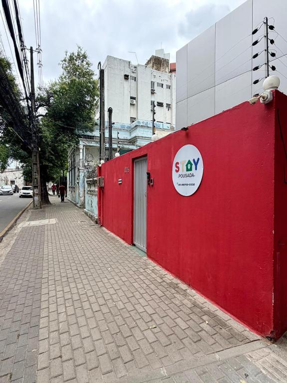 a red wall on the side of a street at STAY POUSADA in Recife