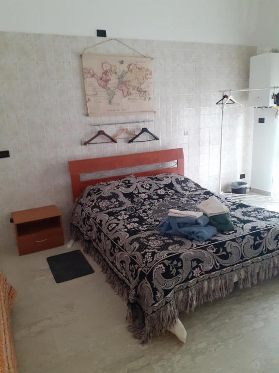 a bedroom with a bed with a black and white blanket at Fashion room in Altamura