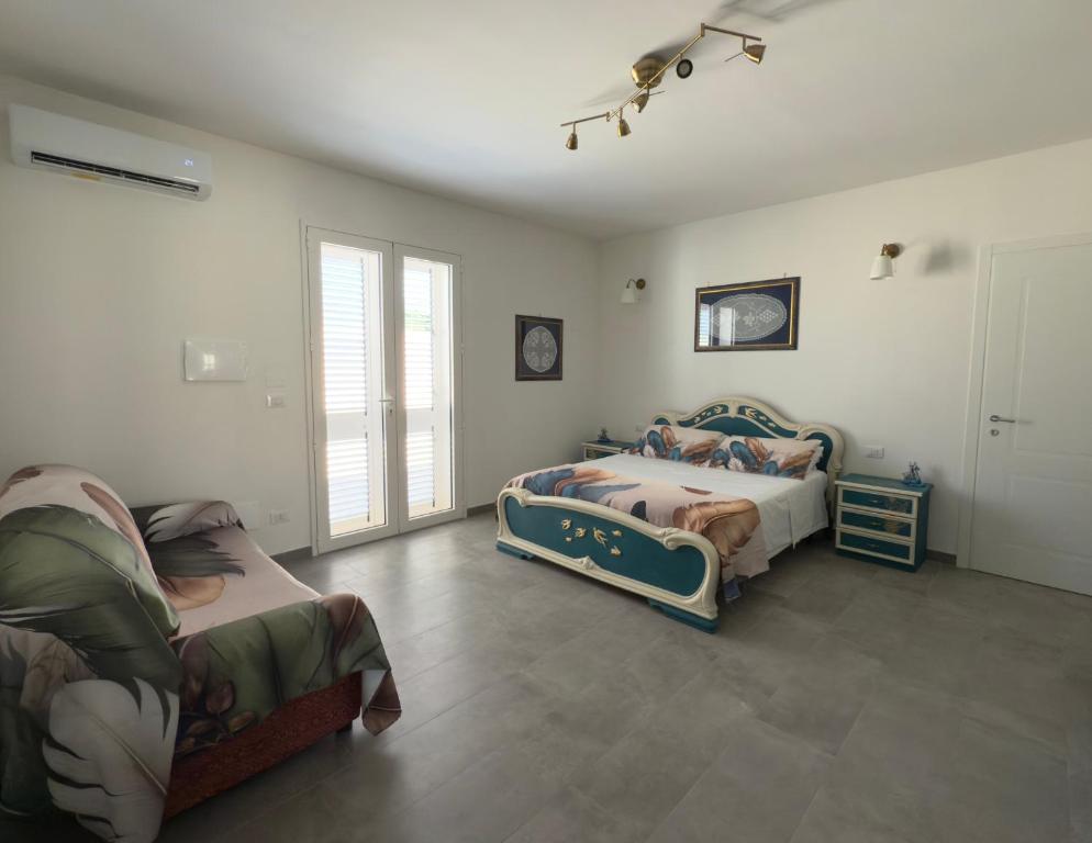 a bedroom with two beds and a window at Casa della Cittadella in Noto