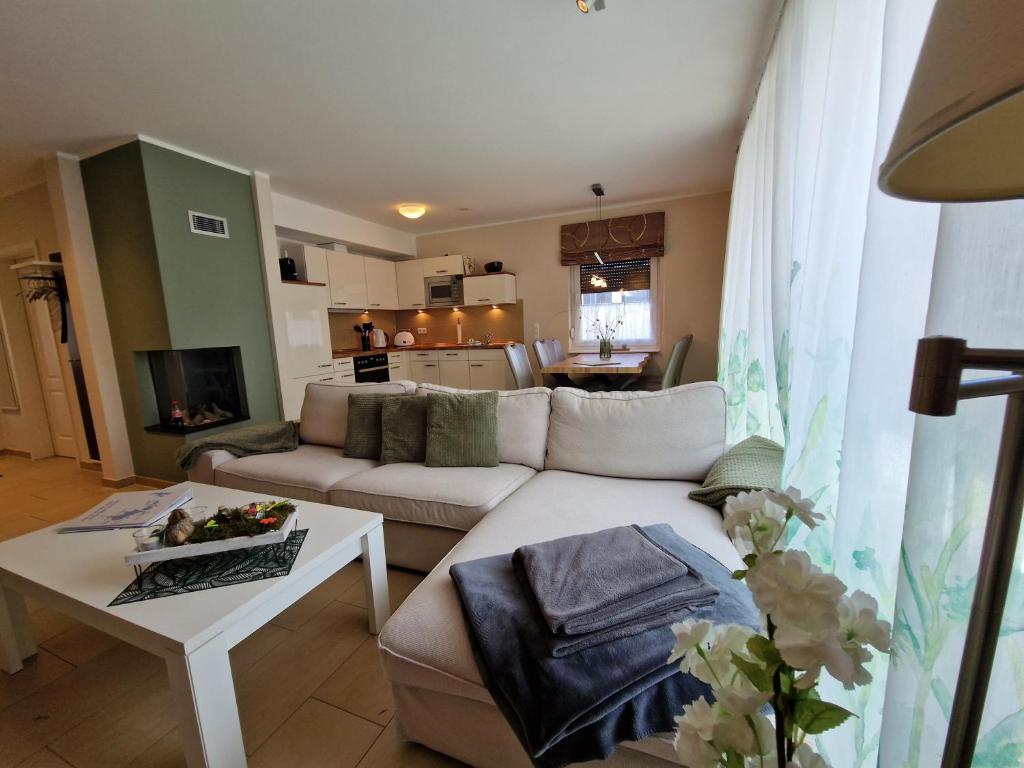 a living room with a couch and a table at Ferienhaus WellNest in Göhren-Lebbin