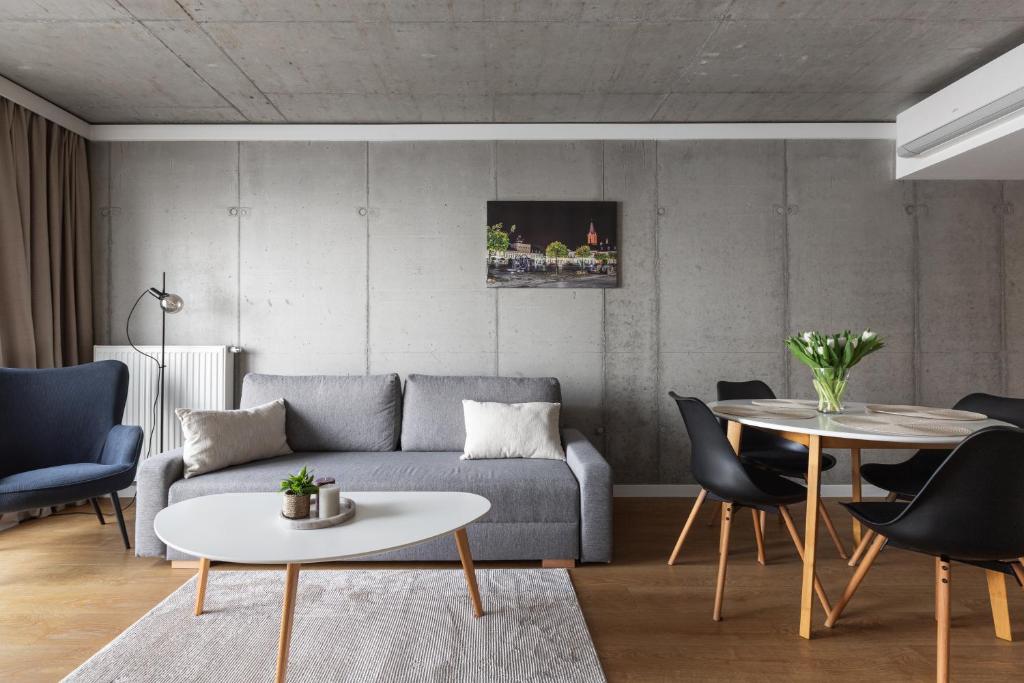 a living room with a couch and a table at River Side Apartments in Oświęcim