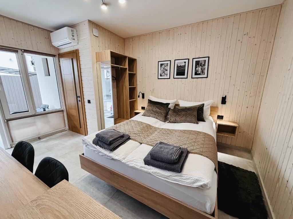 a bedroom with a large bed with pillows on it at Old Friend Guest House in Berehove