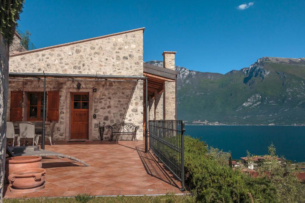 a house with a patio with a view of a lake at VillaLimone in Limone sul Garda