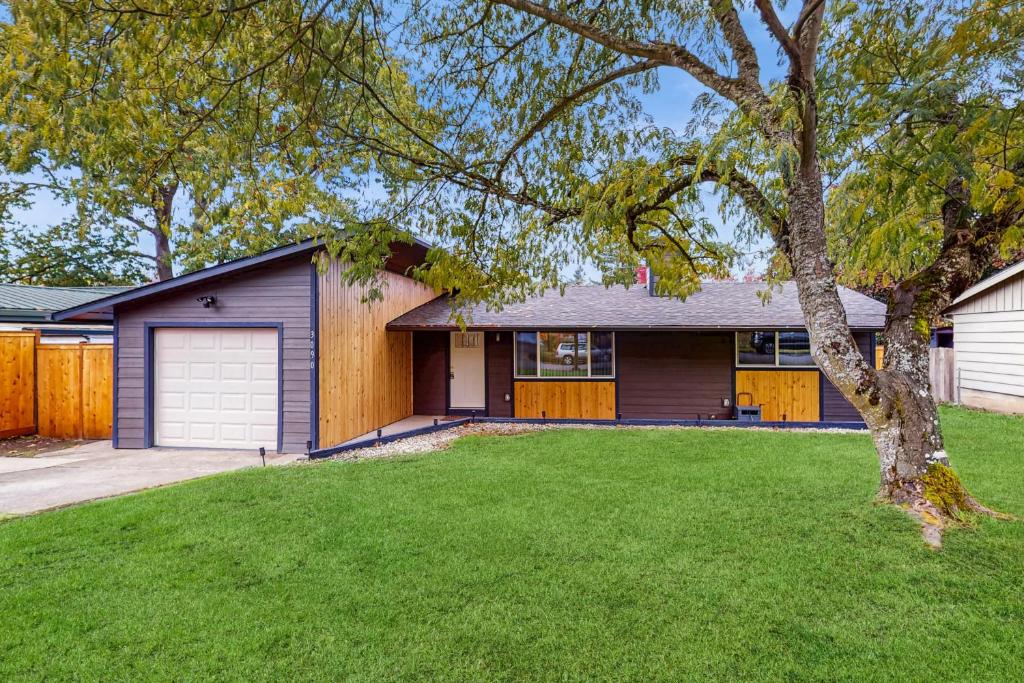 a house with a garage and a tree at Mountain-View Patio, 1 Mi From UO Campus in Eugene